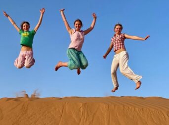 People Jump in Desert