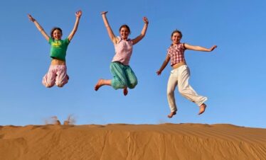 People Jump in Desert