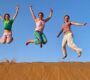 People Jump in Desert