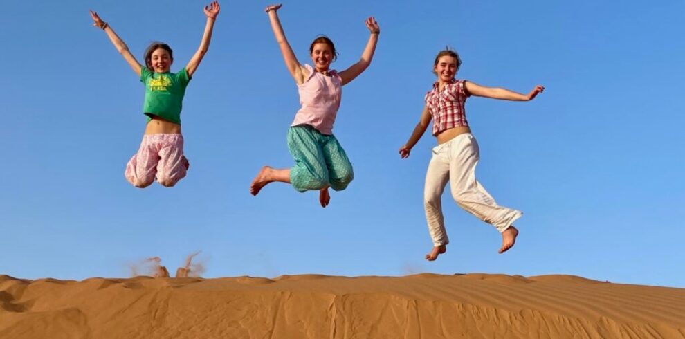 People Jump in Desert