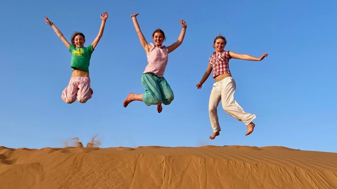 People Jump in Desert